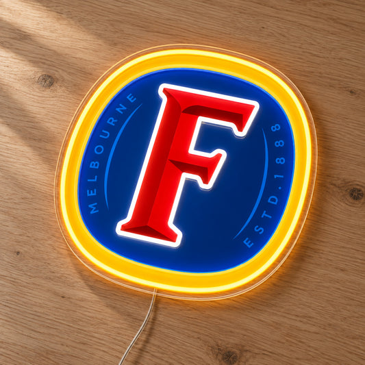 Fosters LED Neon Sign, featuring beer-brand logo displayed on a wooden surface.