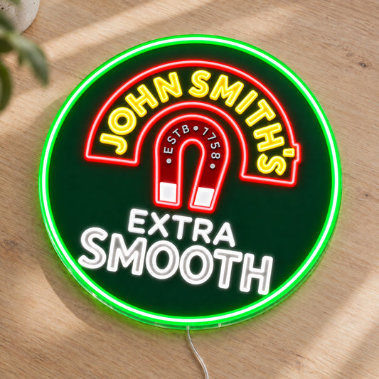 John Smith's LED Neon Sign, featuring beer-brand logo displayed on a wooden surface.