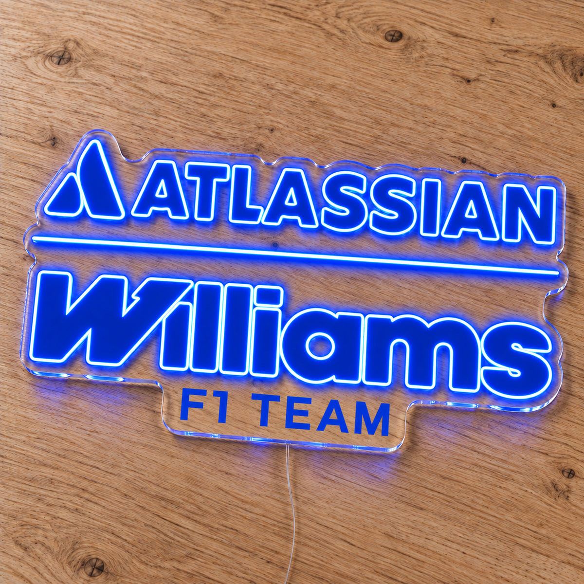 Williams F1 LED Neon Sign, featuring team logo displayed on a wooden surface.