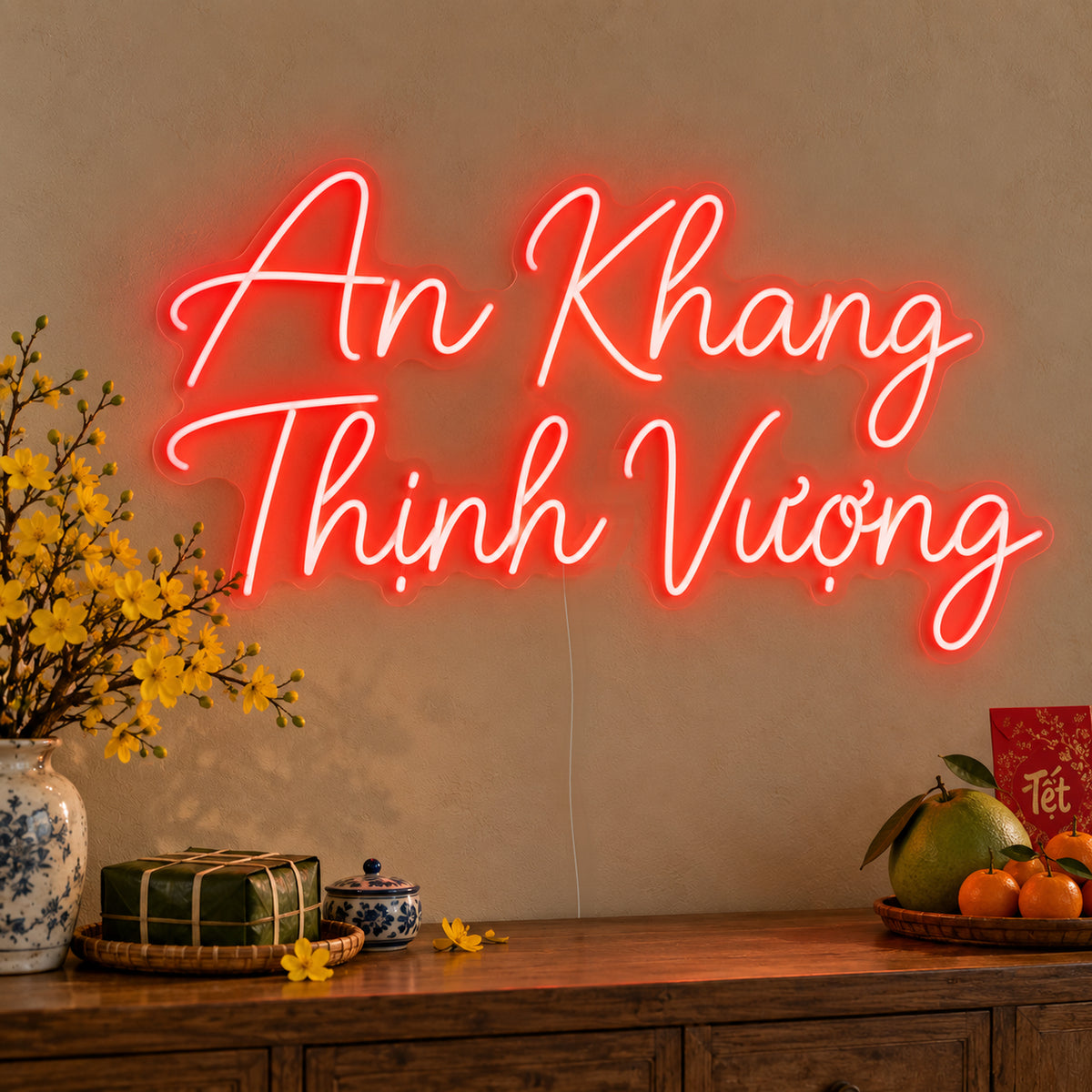 An Khang Thịnh Vượng Neon Sign on clear cut-to-shape acrylic, illuminated on a wall in a styled celebration setting