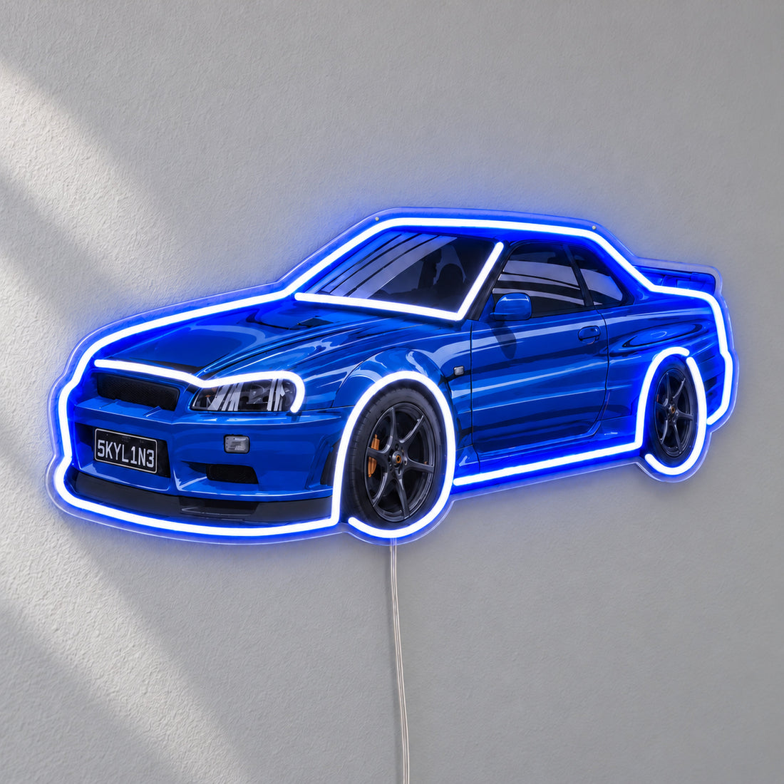 Nissan Skyline R34 LED Neon Sign in blue and white, featuring Nissan Skyline R34 car design on a light wall.