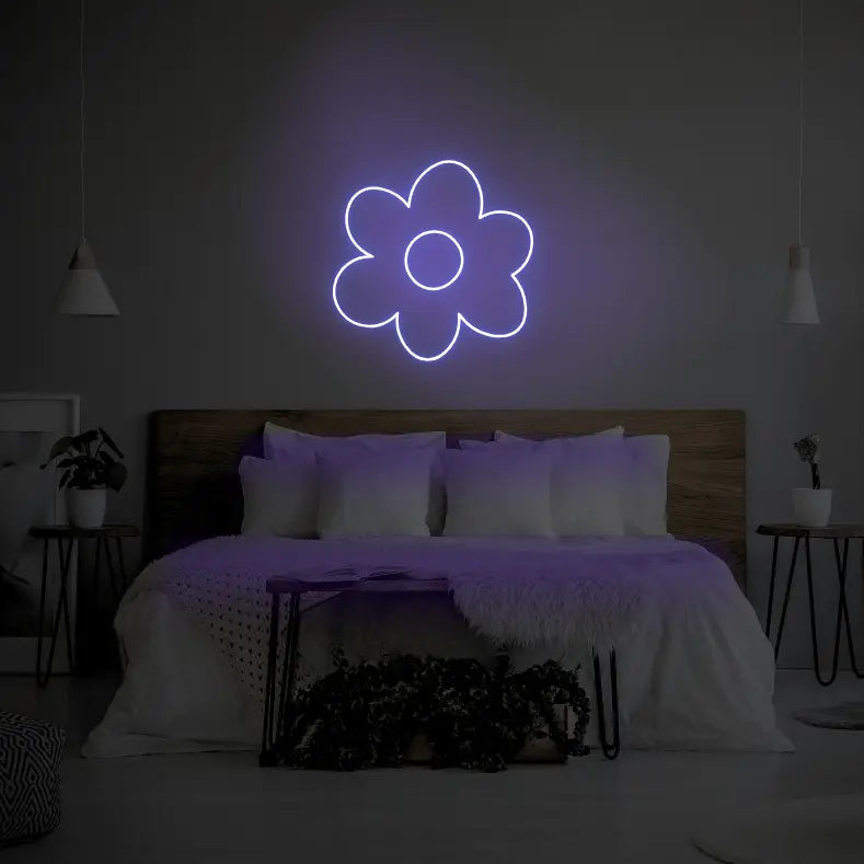Flower LED Neon Light Sign in purple, featuring flower outline illuminated above a bed.