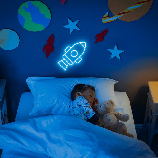Rocket LED Neon Light Sign in blue, featuring rocket outline illuminated on a space-themed bedroom wall.