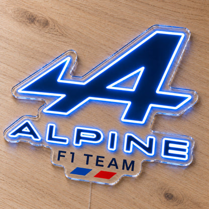 Alpine F1 LED Neon Sign, featuring team logo displayed on a wooden surface.