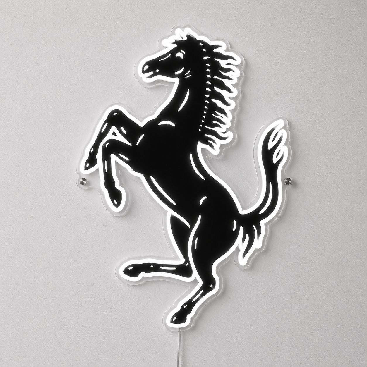 A black and white Ferrari prancing horse wall sign mounted on a light gray wall.
