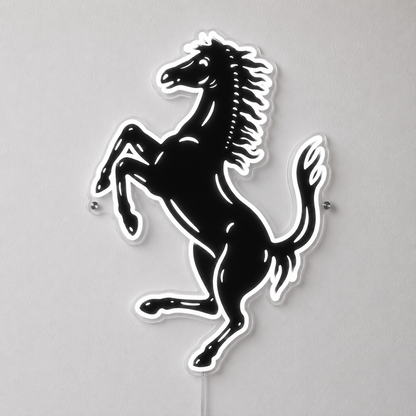A black and white Ferrari prancing horse wall sign mounted on a light gray wall.