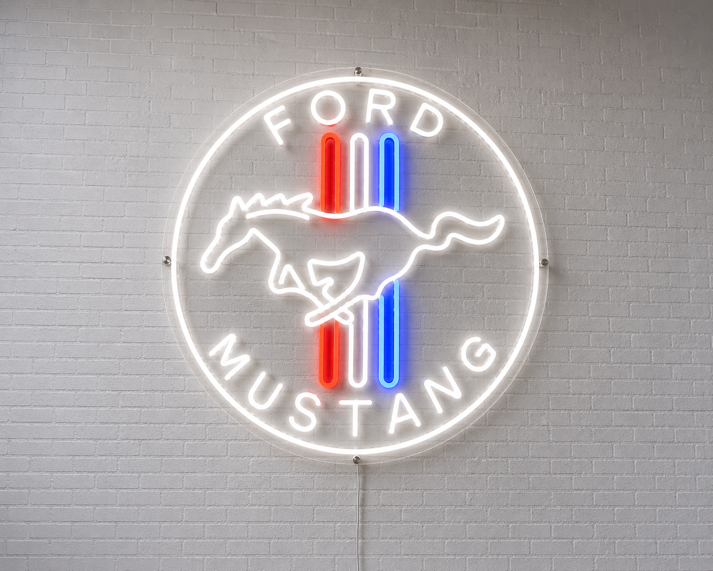 A circular Ford Mustang neon sign mounted on a white brick wall, featuring a white horse logo with red and blue vertical stripes and the words 'FORD MUSTANG' in glowing white lettering.