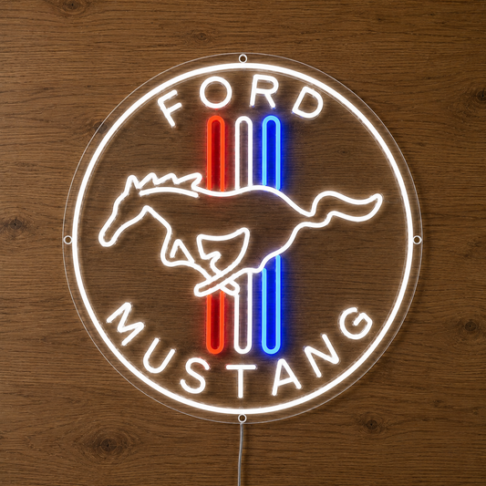 A circular LED neon-style Ford Mustang sign mounted against a wooden wall. The sign features a white glowing outline with the words 'FORD' at the top and 'MUSTANG' at the bottom, a white running horse silhouette, and three vertical stripes in red and blue in the center.