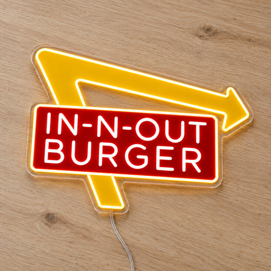 In-N-Out Burger LED Neon Sign, featuring illuminated brand logo on a wooden surface.
