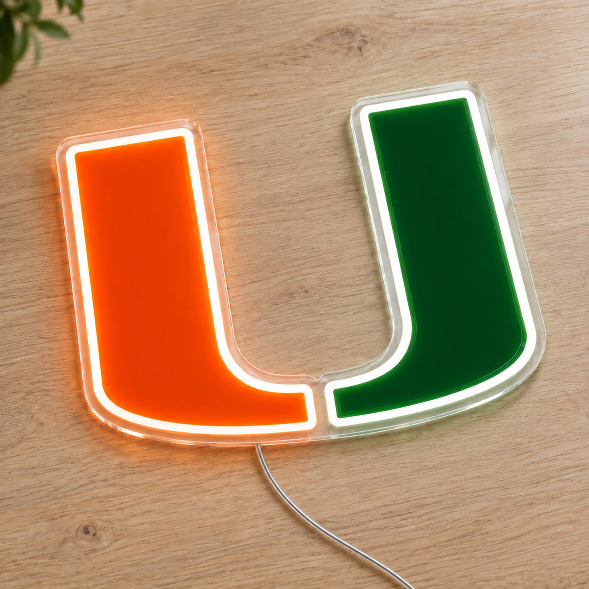 Miami Hurricanes LED Neon Sign, featuring team logo displayed on a wooden surface.