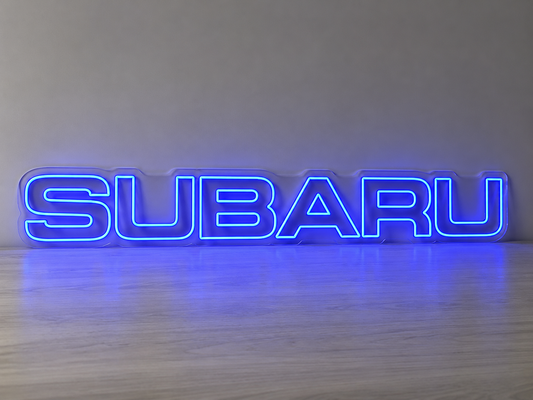 Neon sign with 'SUBARU' logo on a wooden surface