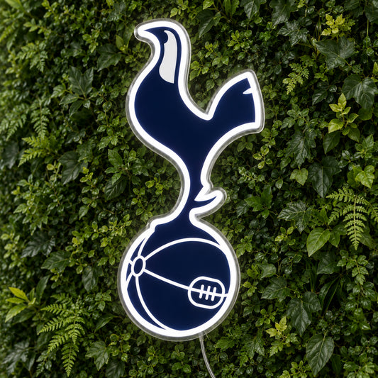Tottenham LED Neon Sign, featuring team logo displayed on a green foliage wall.