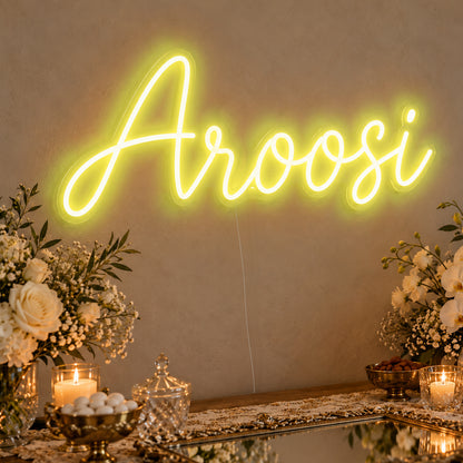 Aroosi Neon Sign in yellow LED neon on clear acrylic, angled view