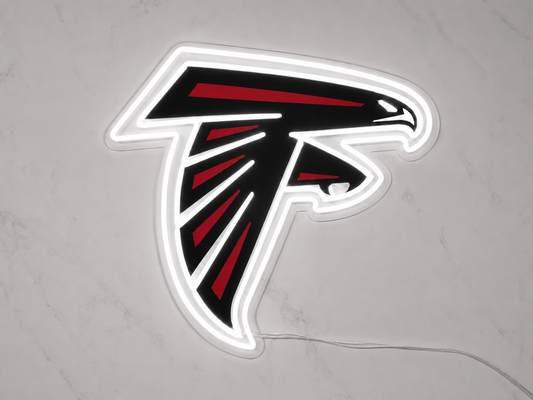 Atlanta Falcons LED neon sign with falcon logo glowing white and red on a marble wall
