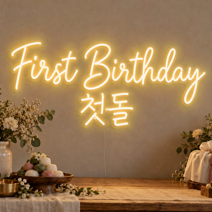 First Birthday English & Korean Neon Sign in gold LED neon on clear acrylic, angled view