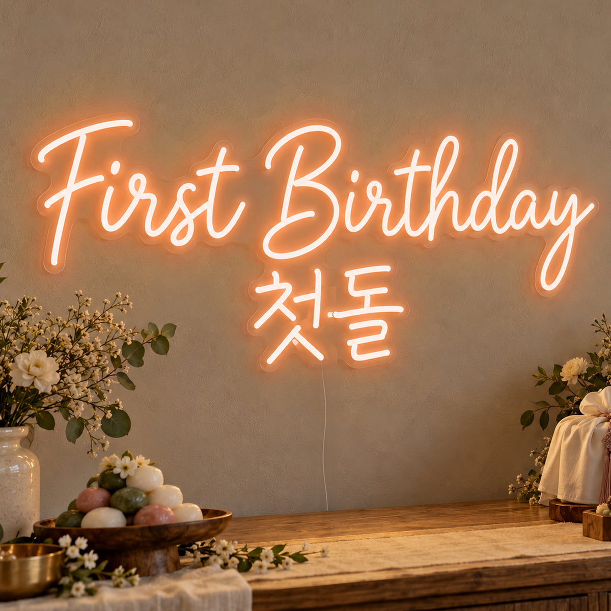 First Birthday English & Korean Neon Sign in orange LED neon on clear acrylic, angled view