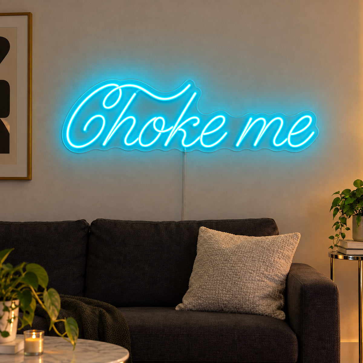 Ice Blue version of the Choke Me Neon Sign, shown above a charcoal sofa.