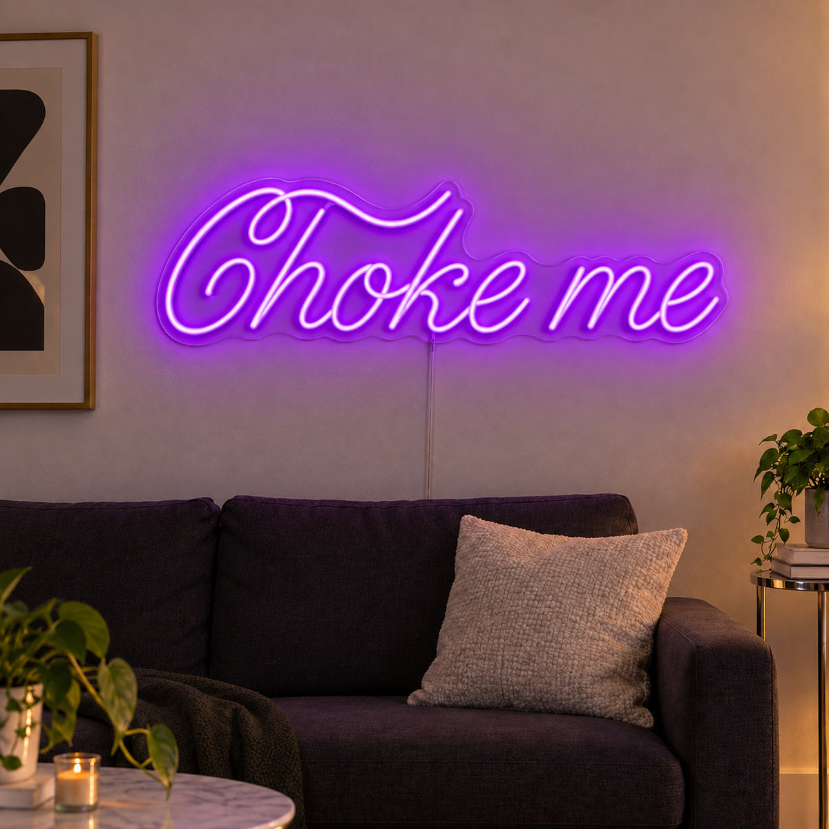 Choke Me Neon Sign with purple lighting, displayed above a charcoal sofa.