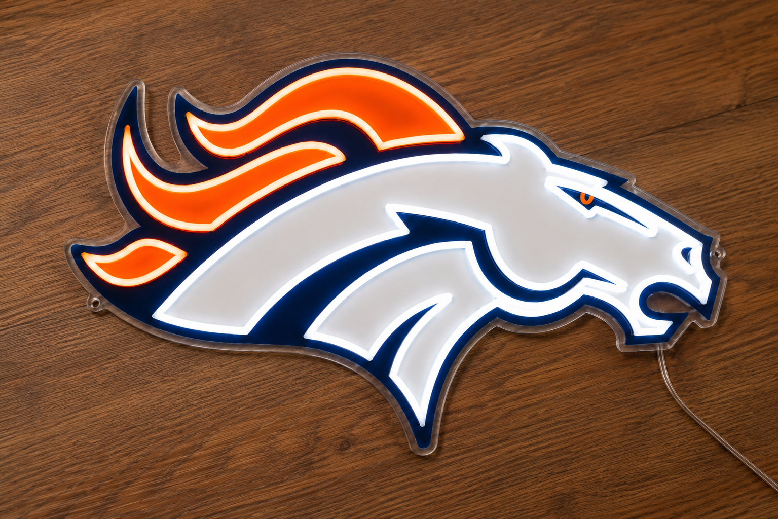 Angled view of Denver Broncos LED neon light sign on a wood surface