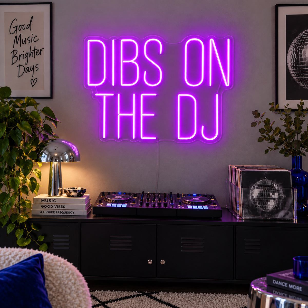 Dibs On The DJ Neon Sign with purple lighting, displayed above a home DJ setup.