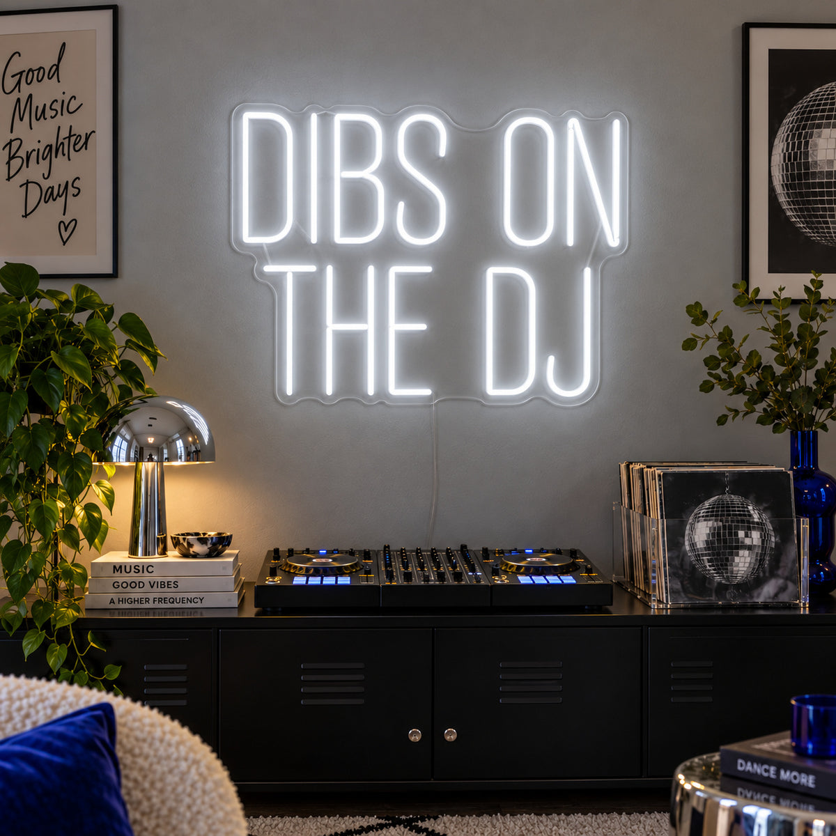 Dibs On The DJ Neon Sign glowing white above a home DJ setup.