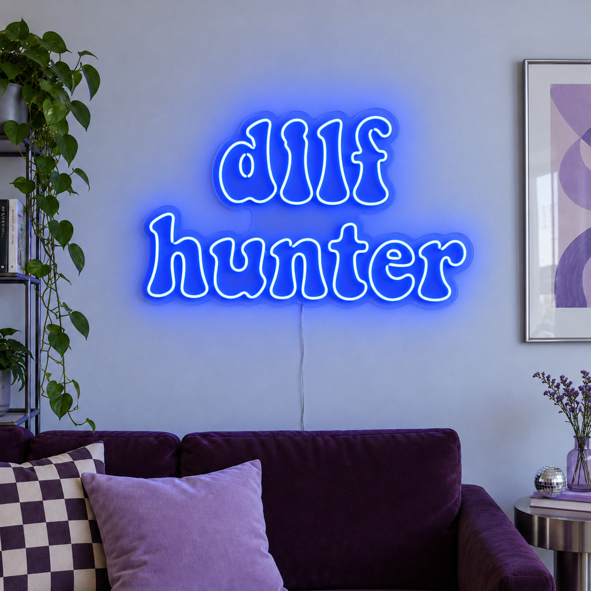 DILF Hunter Neon Sign glowing blue above a sofa with purple cushions.