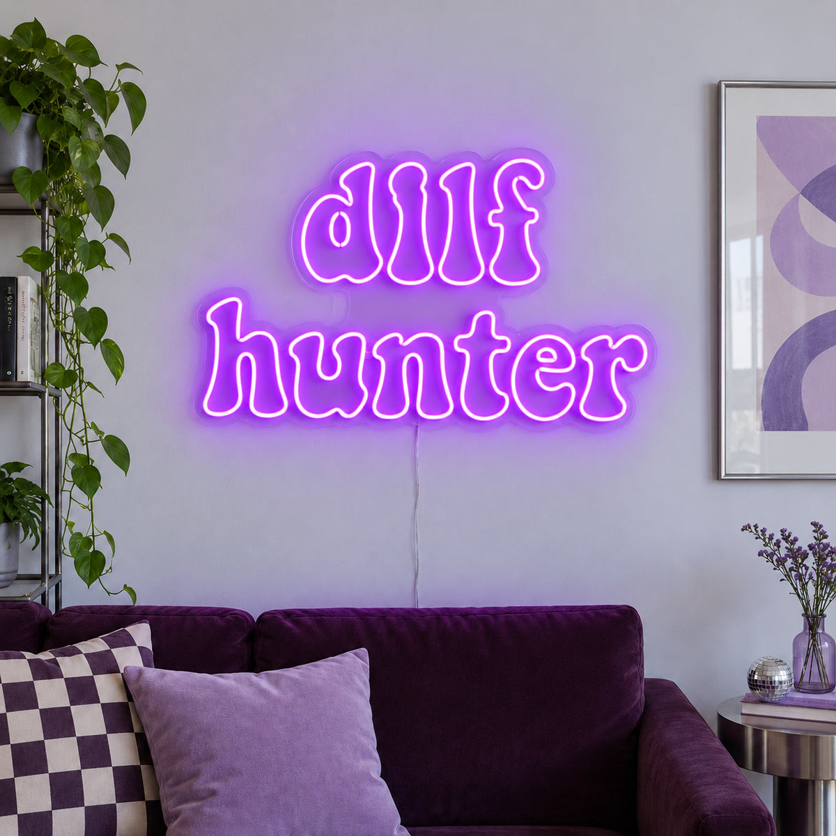 DILF Hunter Neon Sign with purple lighting, displayed above a sofa with purple cushions.