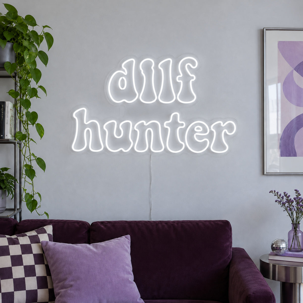 DILF Hunter Neon Sign, RGB colour-changing option shown in white above a sofa with purple cushions.