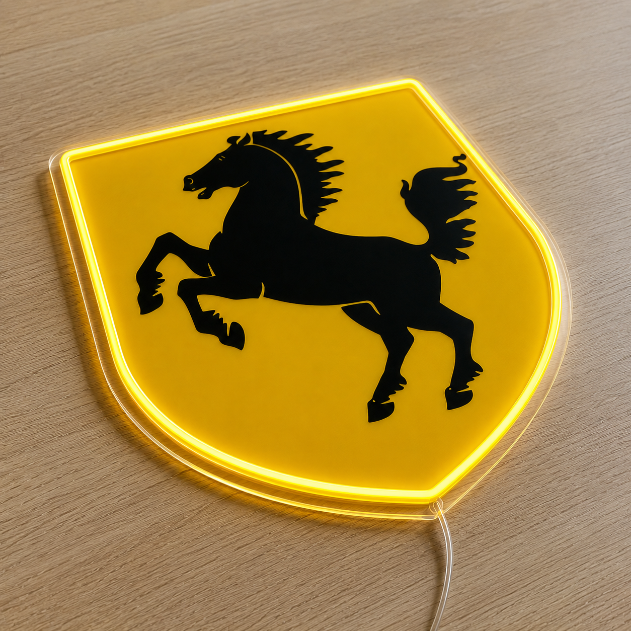 Low angled view of Ferrari shield LED neon light sign with yellow glow
