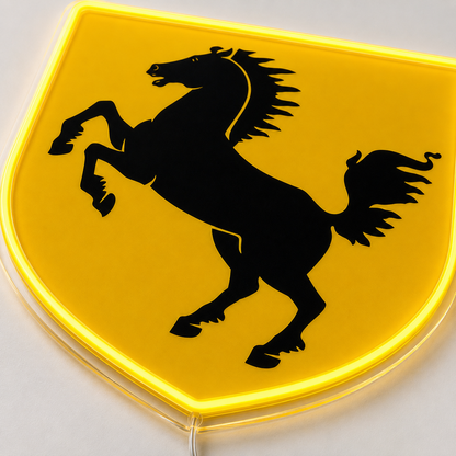 Close-up detail of Ferrari shield neon sign showing prancing horse and backlit acrylic edge