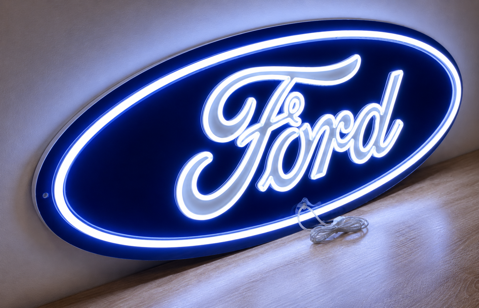 Ford oval neon sign glowing blue and white, angled against a wall
