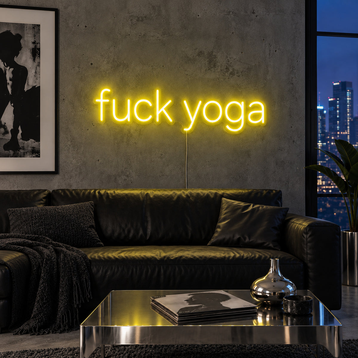 Fuck Yoga Neon Sign with yellow lighting, displayed above a black leather sofa.