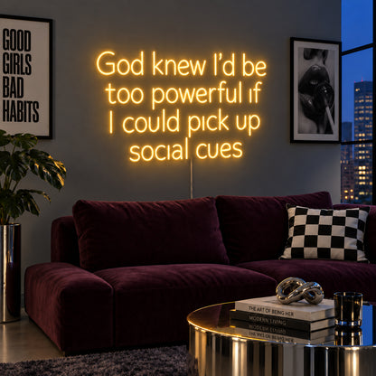 God Knew I'd Be Too Powerful If I Could Pick Up Social Cues Neon Sign glowing gold above a burgundy sofa.
