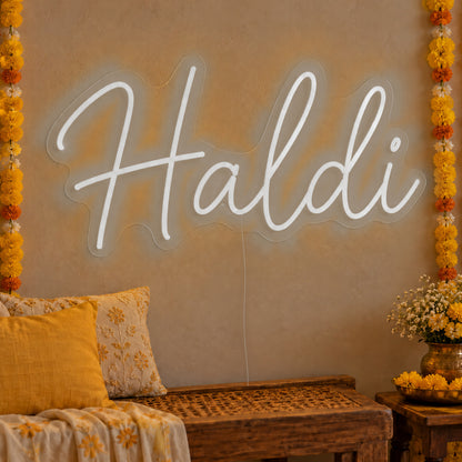 Haldi Neon Sign in white LED neon on clear acrylic, angled view