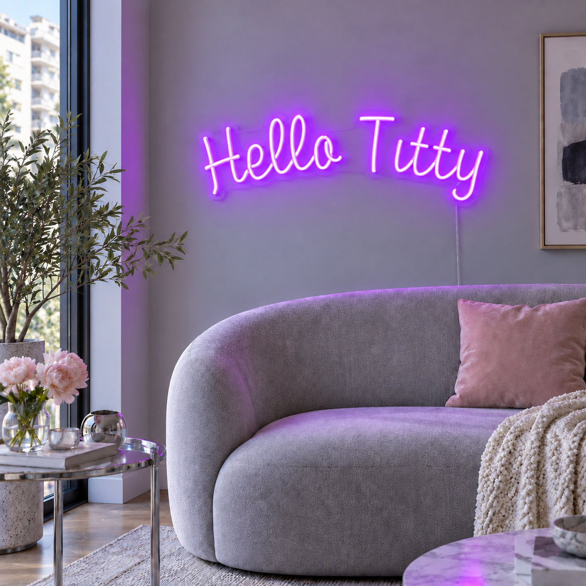 Hello Titty Neon Sign with purple lighting, displayed above a curved grey sofa.