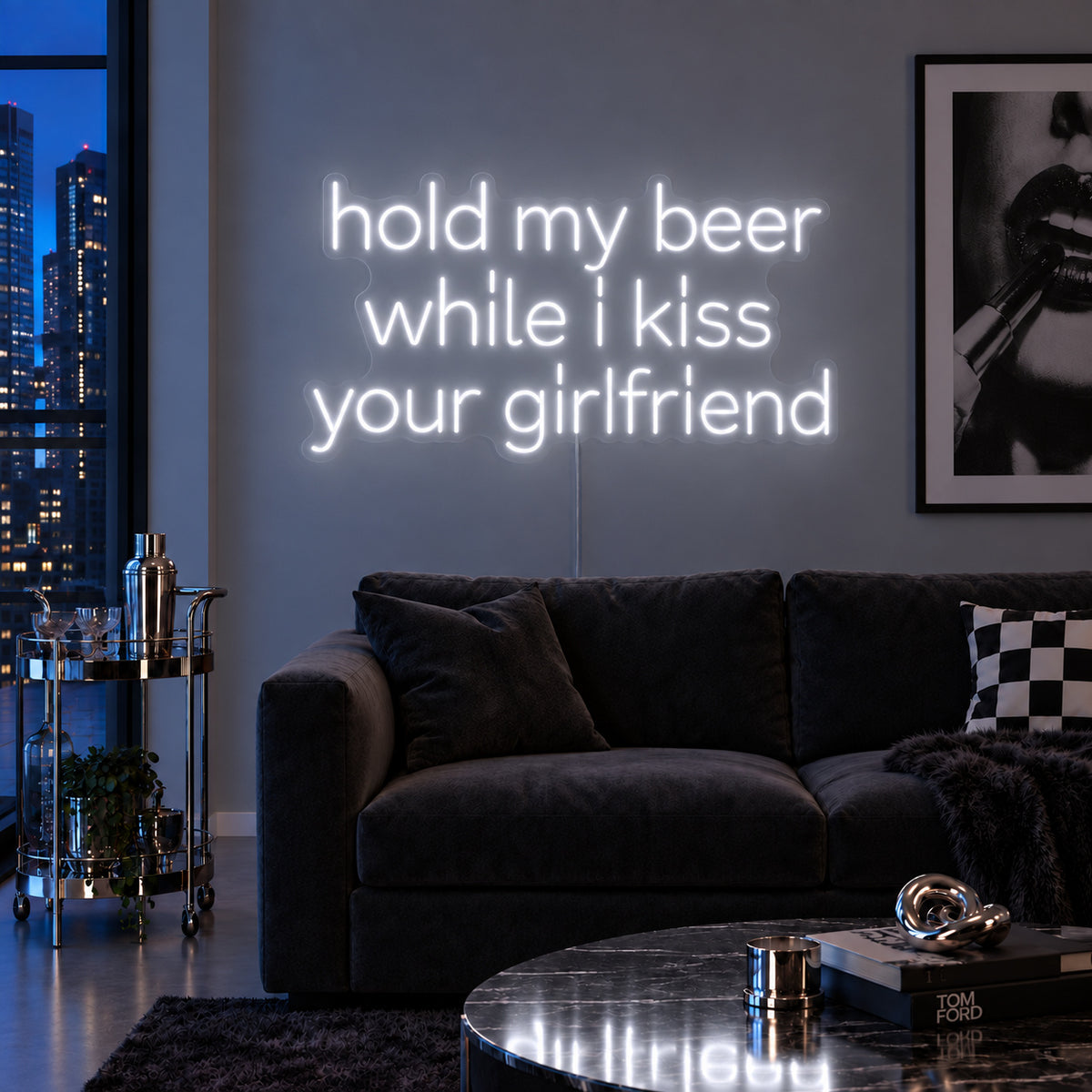 Hold My Beer While I Kiss Your Girlfriend Neon Sign glowing white above a burgundy sofa.
