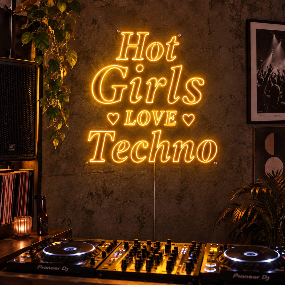 Hot Girls Love Techno Neon Sign glowing gold with heart details above a DJ setup.