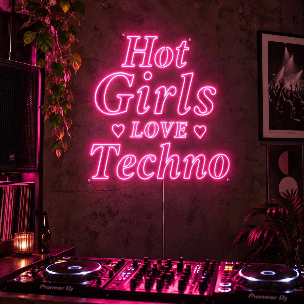 Hot Girls Love Techno Neon Sign glowing pink with heart details above a DJ setup.
