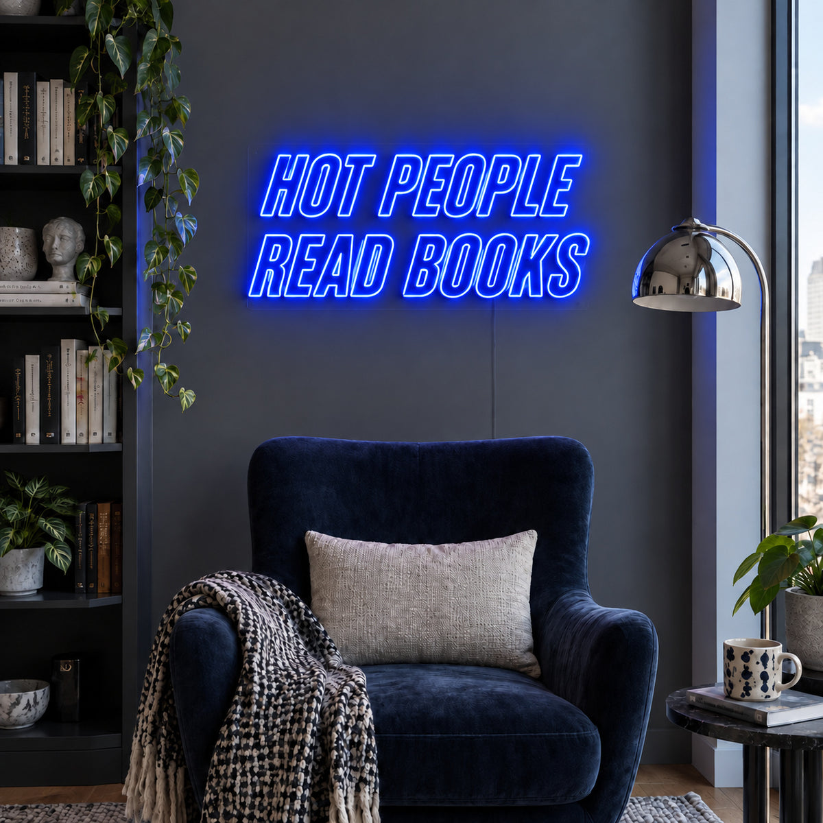 Hot People Read Books Neon Sign glowing blue above a blue reading chair.
