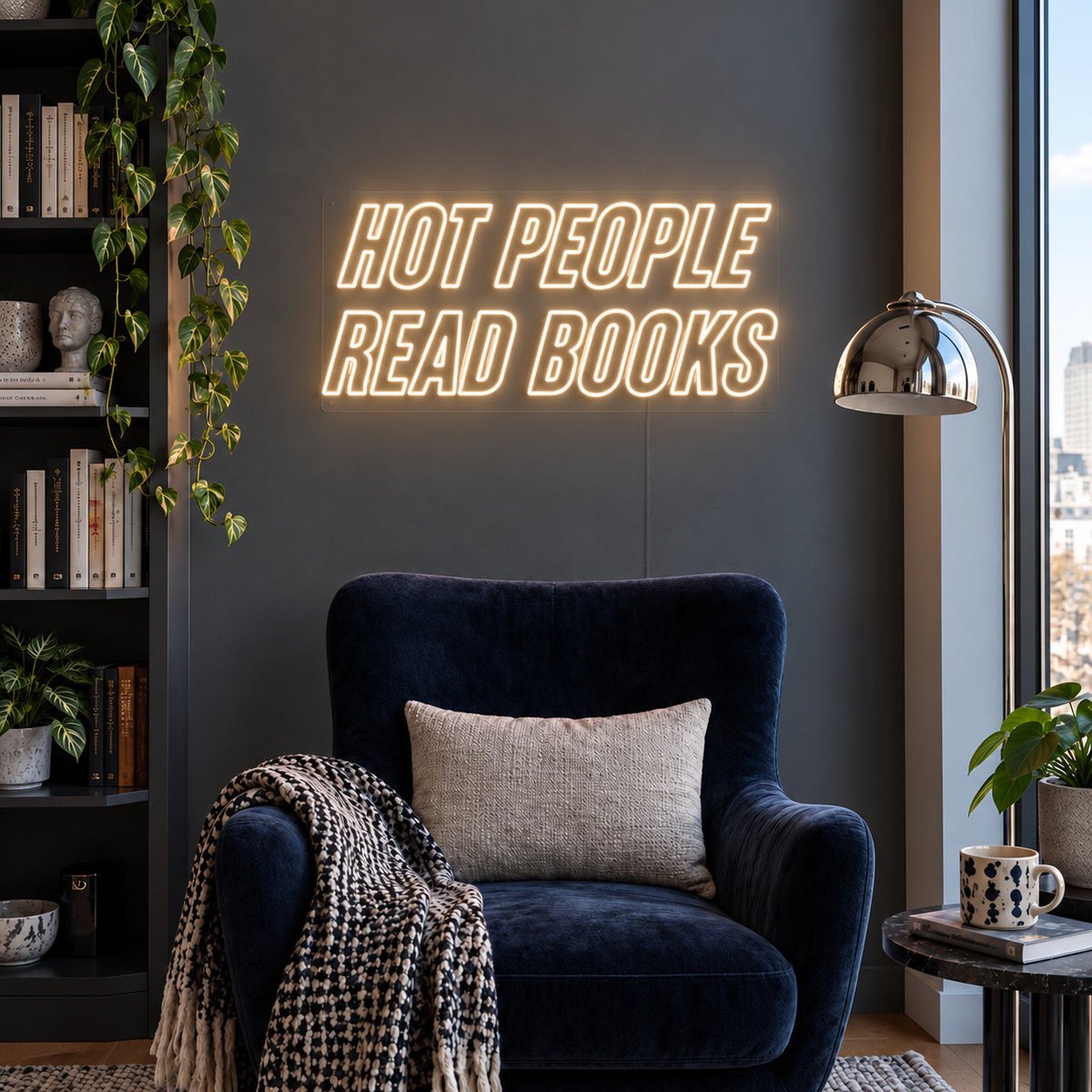 Warm White version of the Hot People Read Books Neon Sign, shown above a blue reading chair.