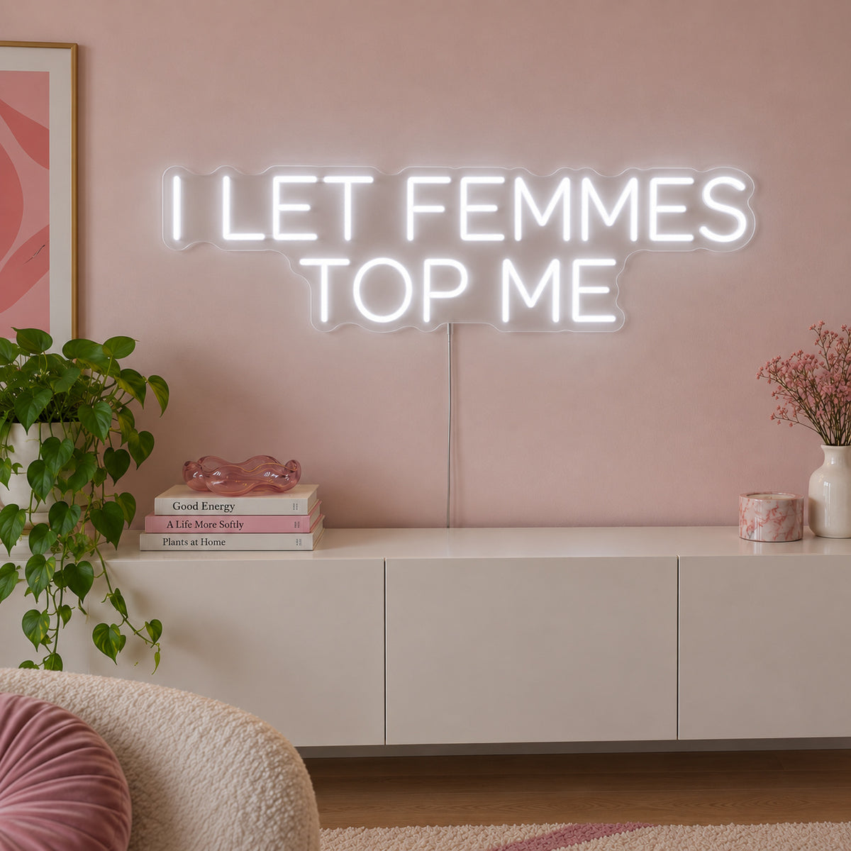 I Let Femmes Top Me Neon Sign, RGB colour-changing option shown in white in rounded lettering above a white sideboard.