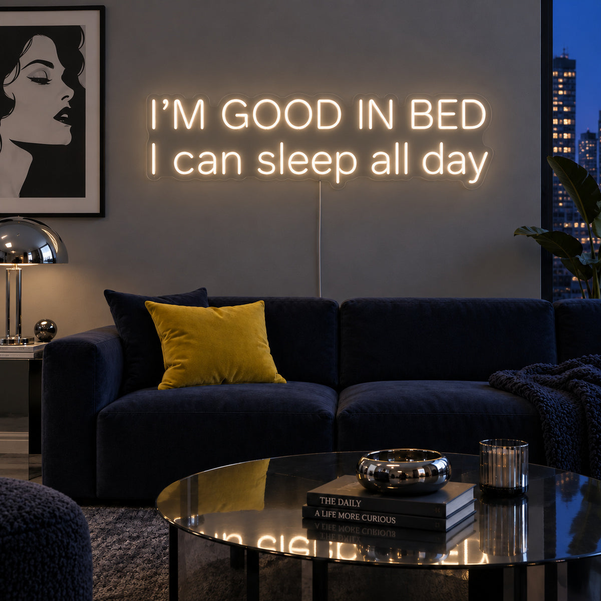 Warm White version of the I'm Good In Bed I Can Sleep All Day Neon Sign, shown above a navy sofa.