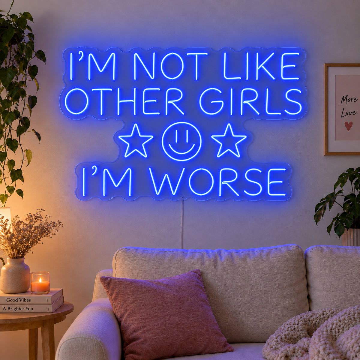 I'm Not Like Other Girls I'm Worse Neon Sign glowing blue with stars and a smiley face above a cream sofa.