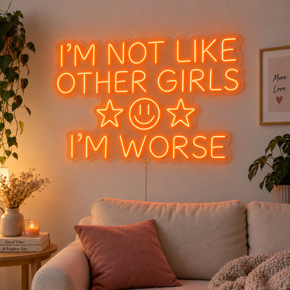 Orange version of the I'm Not Like Other Girls I'm Worse Neon Sign, shown with stars and a smiley face above a cream sofa.