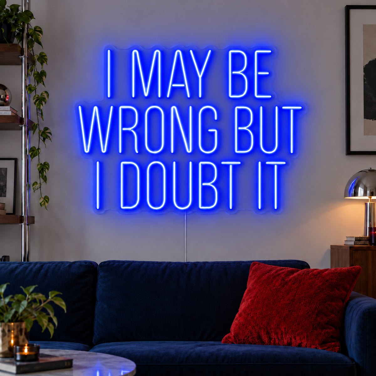 I May Be Wrong But I Doubt It Neon Sign glowing blue above a dark blue sofa.
