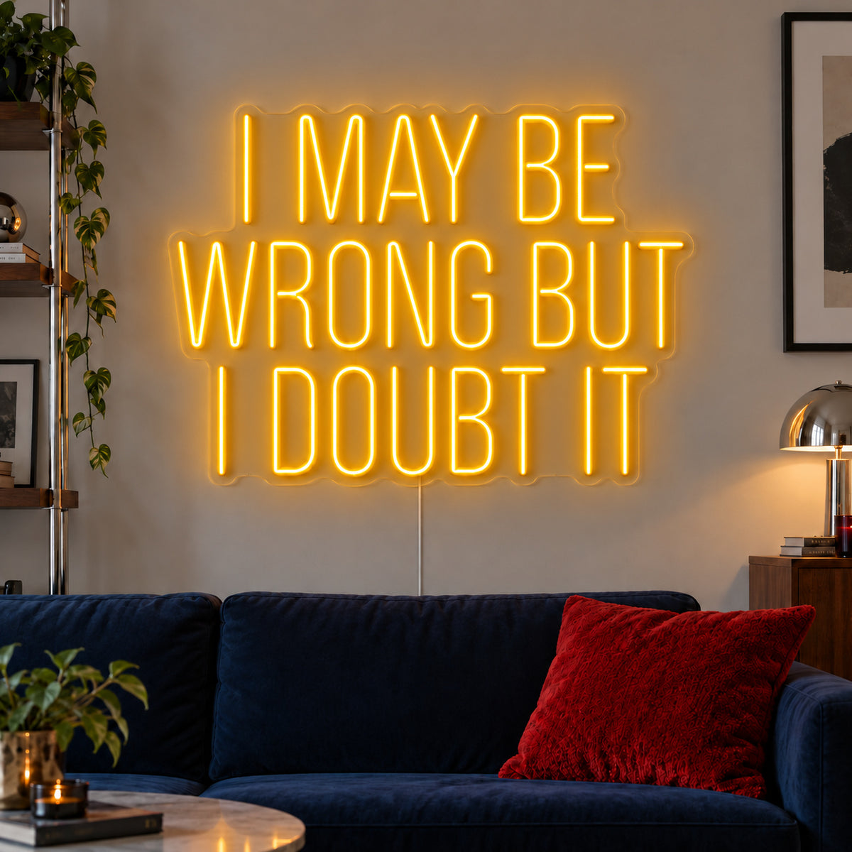 I May Be Wrong But I Doubt It Neon Sign glowing gold above a dark blue sofa.