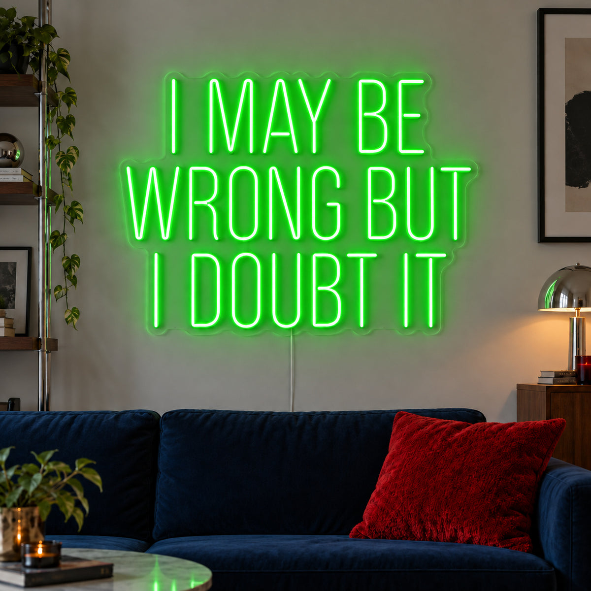 I May Be Wrong But I Doubt It Neon Sign with green lighting, displayed above a dark blue sofa.