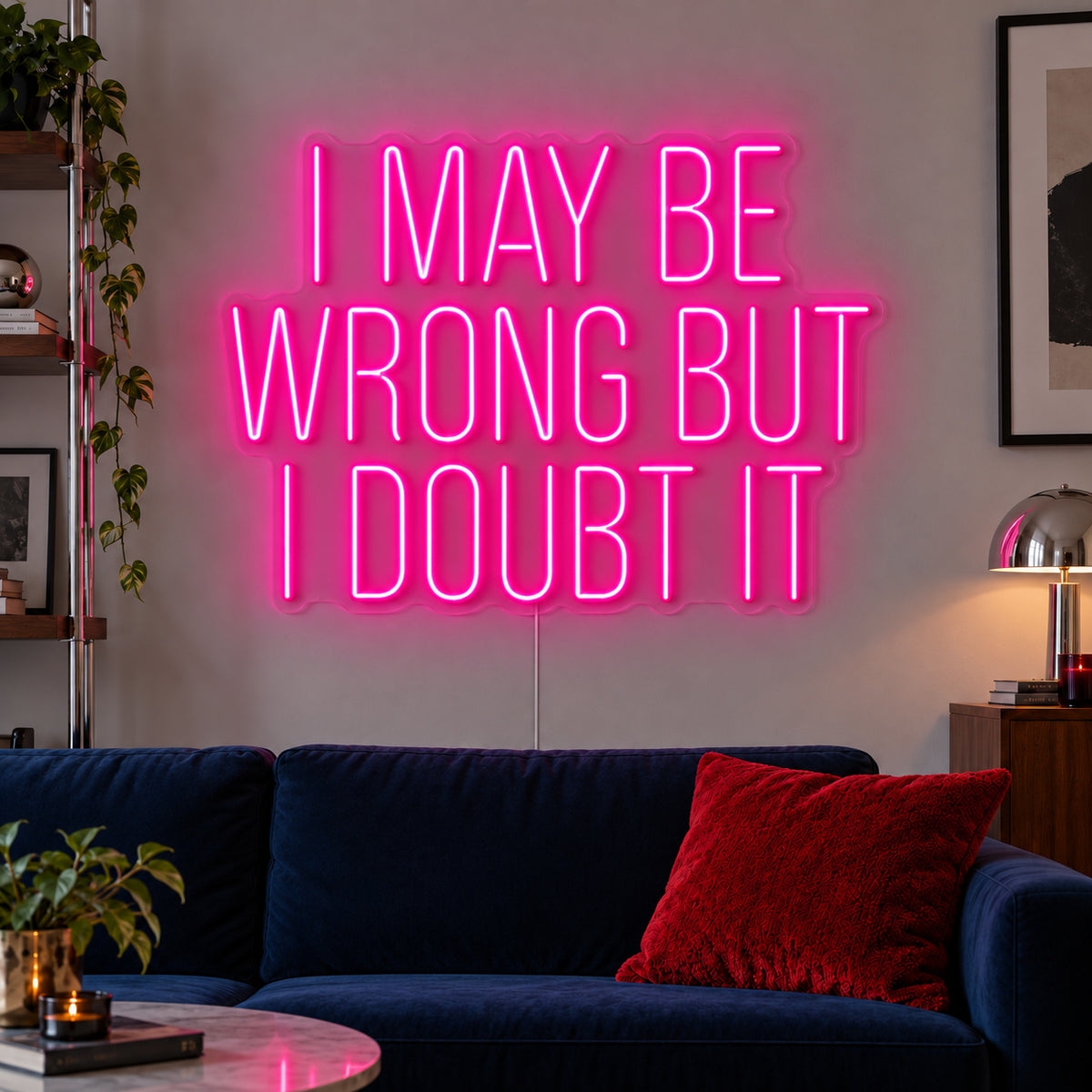 Rose Red version of the I May Be Wrong But I Doubt It Neon Sign, shown above a dark blue sofa.