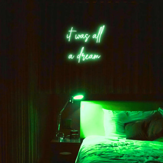 It Was All a Dream LED Neon Light Sign in green, featuring script lettering illuminated above a bed.