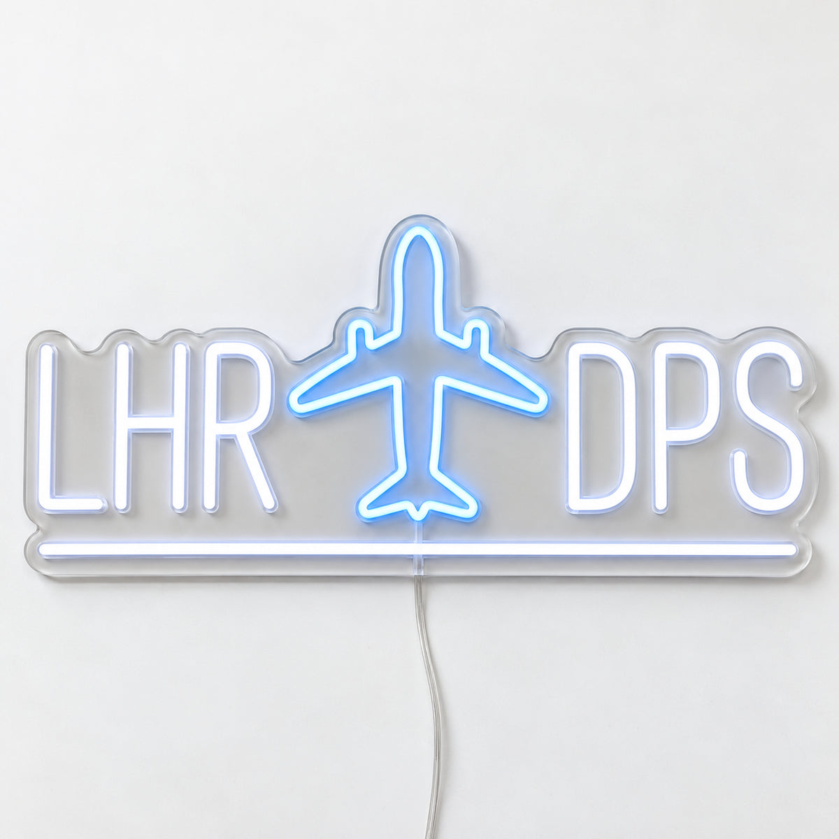 LHR to DPS Flight Route Neon Sign, featuring the LHR to DPS flight route with an aircraft motif, on a single clear acrylic backing displayed on a white surface.